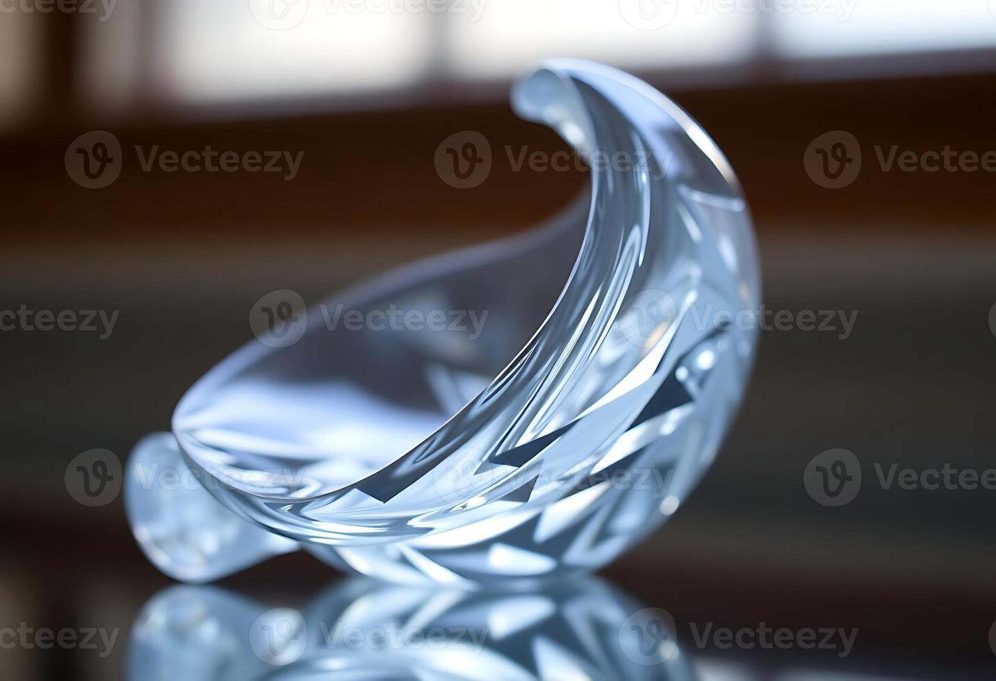 clear glass sculpture sitting on top of a table photo