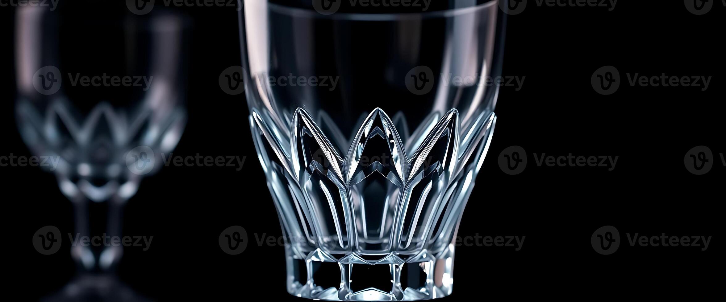 two clear glasses sitting next to each other on a table photo