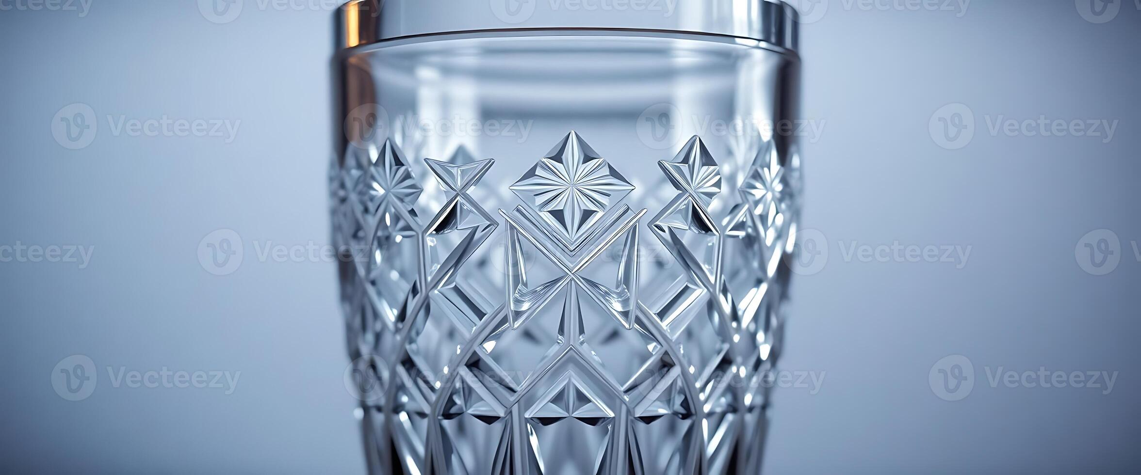 clear glass with a gold rim on a blue background photo