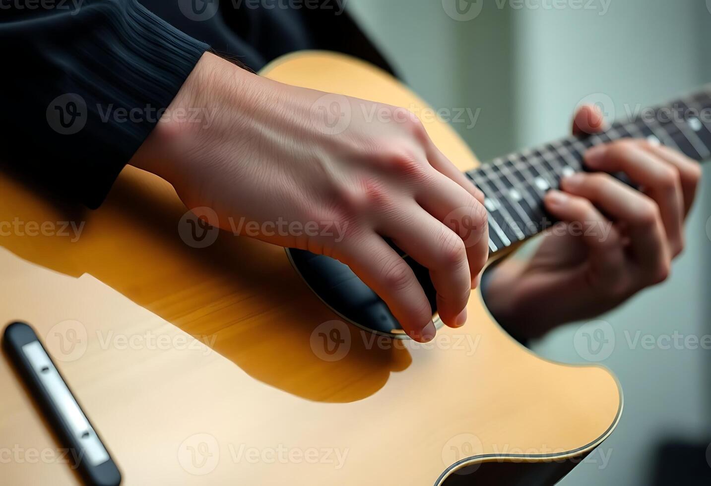 person playing a guitar with their fingers photo