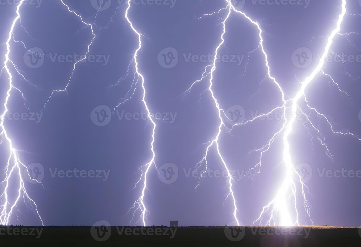 large group of lightning strikes over a field photo
