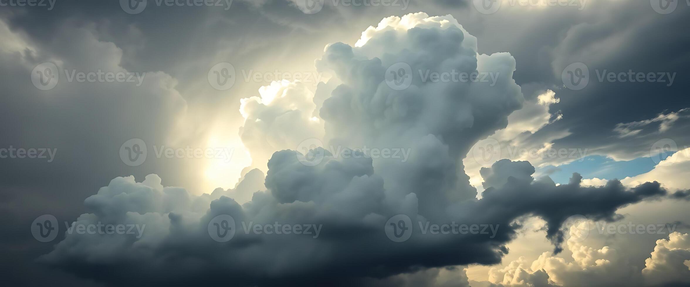 very large cloud in the sky with the sun shining through it photo