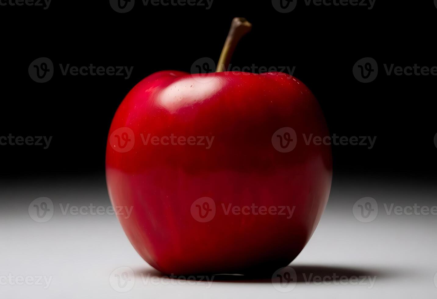 red apple sitting on top of a white table photo