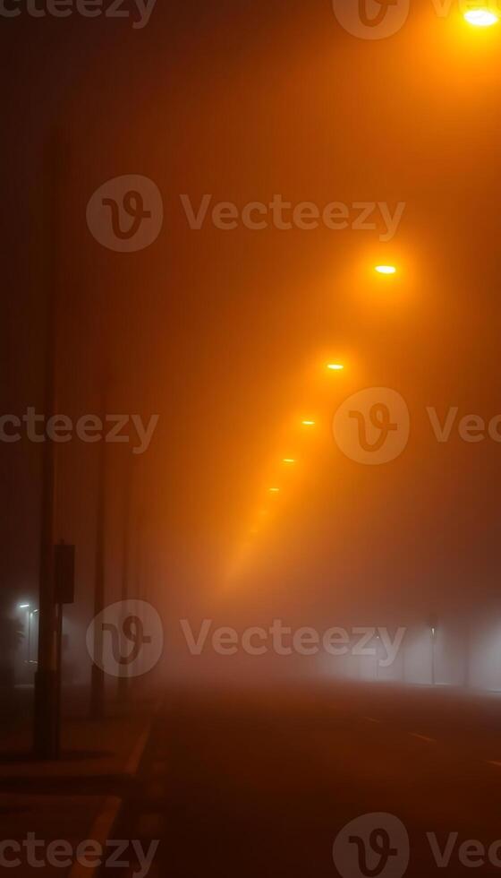 foggy street with street lights on a foggy night photo
