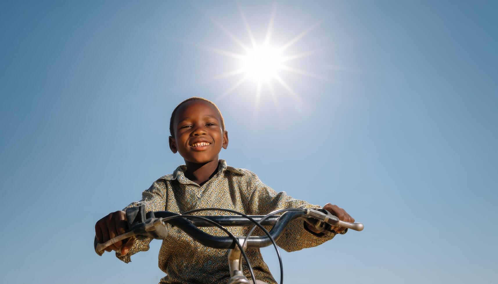 Joyful small boy riding bicycle under bright sun outdoor fun lifestyle happy moment photo