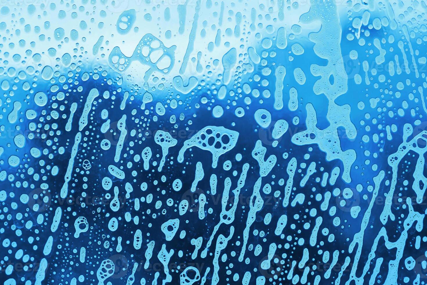 Abstract soap foam pattern on glass photo
