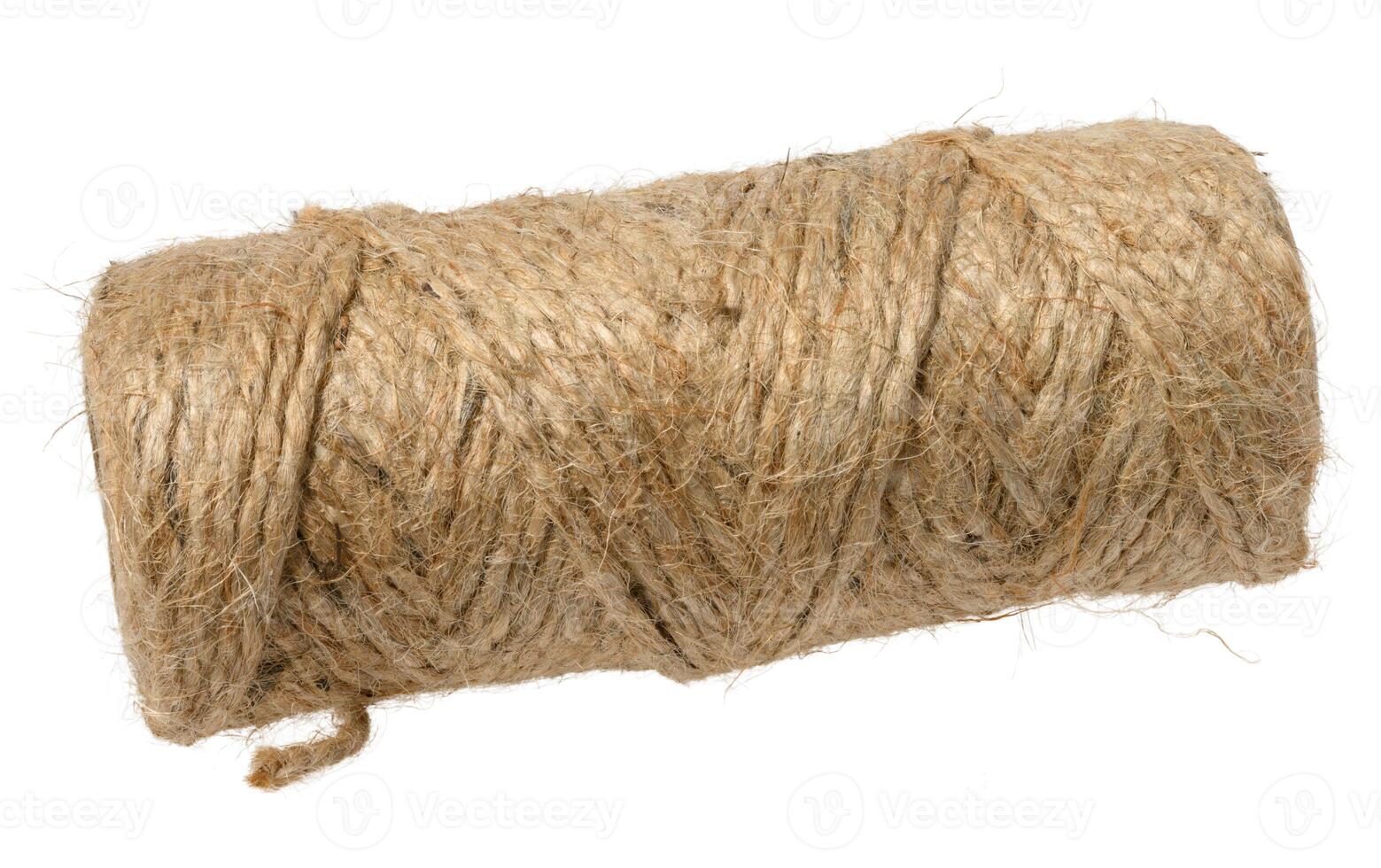 A tightly wound spool of rustic, light brown jute twine with visible fibers, isolated background photo