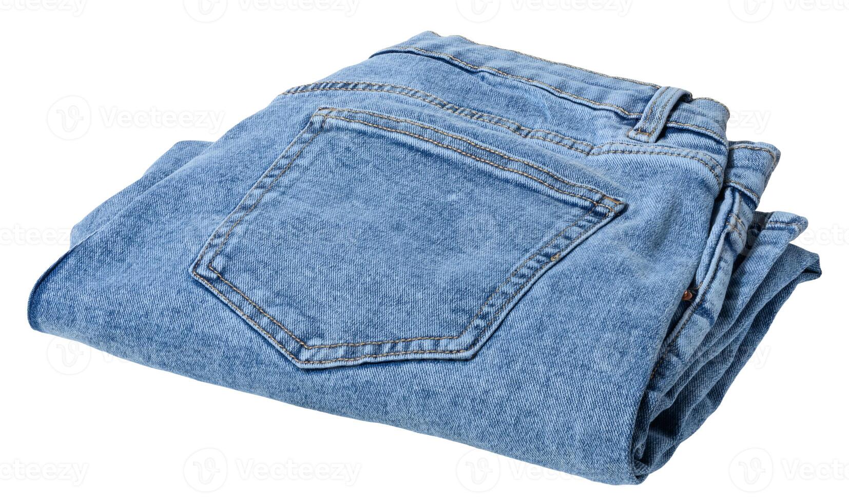 Folded pair of light blue denim jeans, isolated background photo