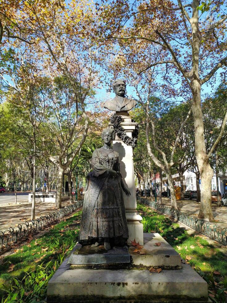 LISBON, PORTUGAL - DECEMBER 04, 2024 Statue of notable figures in a park, under autumn trees. Editorial use. Travel, culture, history. Bronze statues. photo