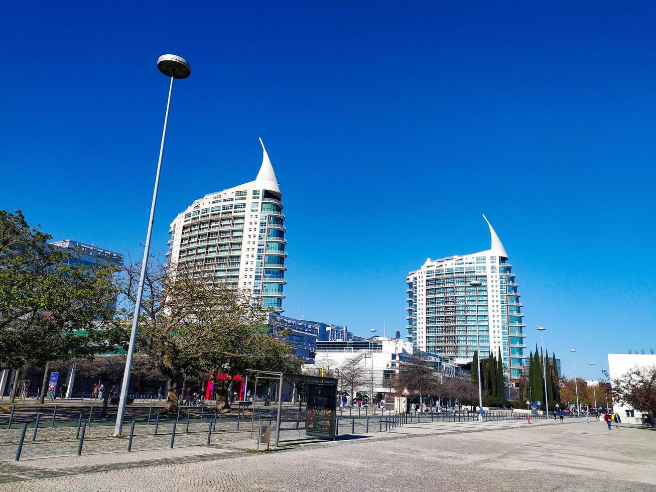 LISBON, PORTUGAL - JANUARY 17, 2025 Modern buildings on a square under a bright blue sky. A scenic cityscape image ideal for travel, architectural, or destinationthemed content. photo
