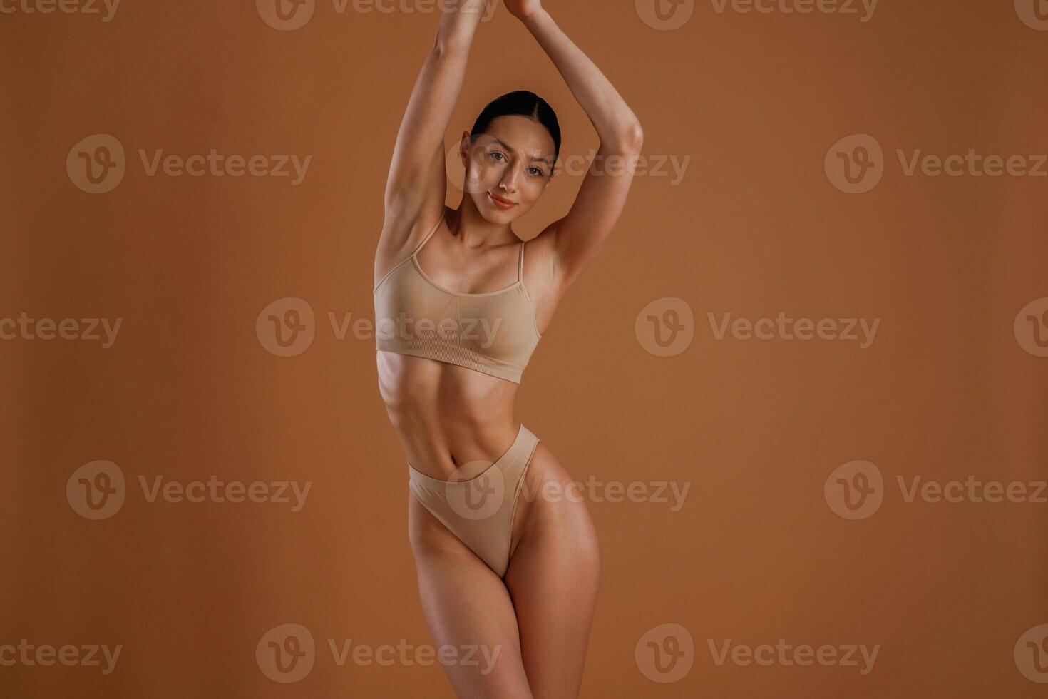 Beautiful model. Woman with slim,, body, shape is posing against background photo