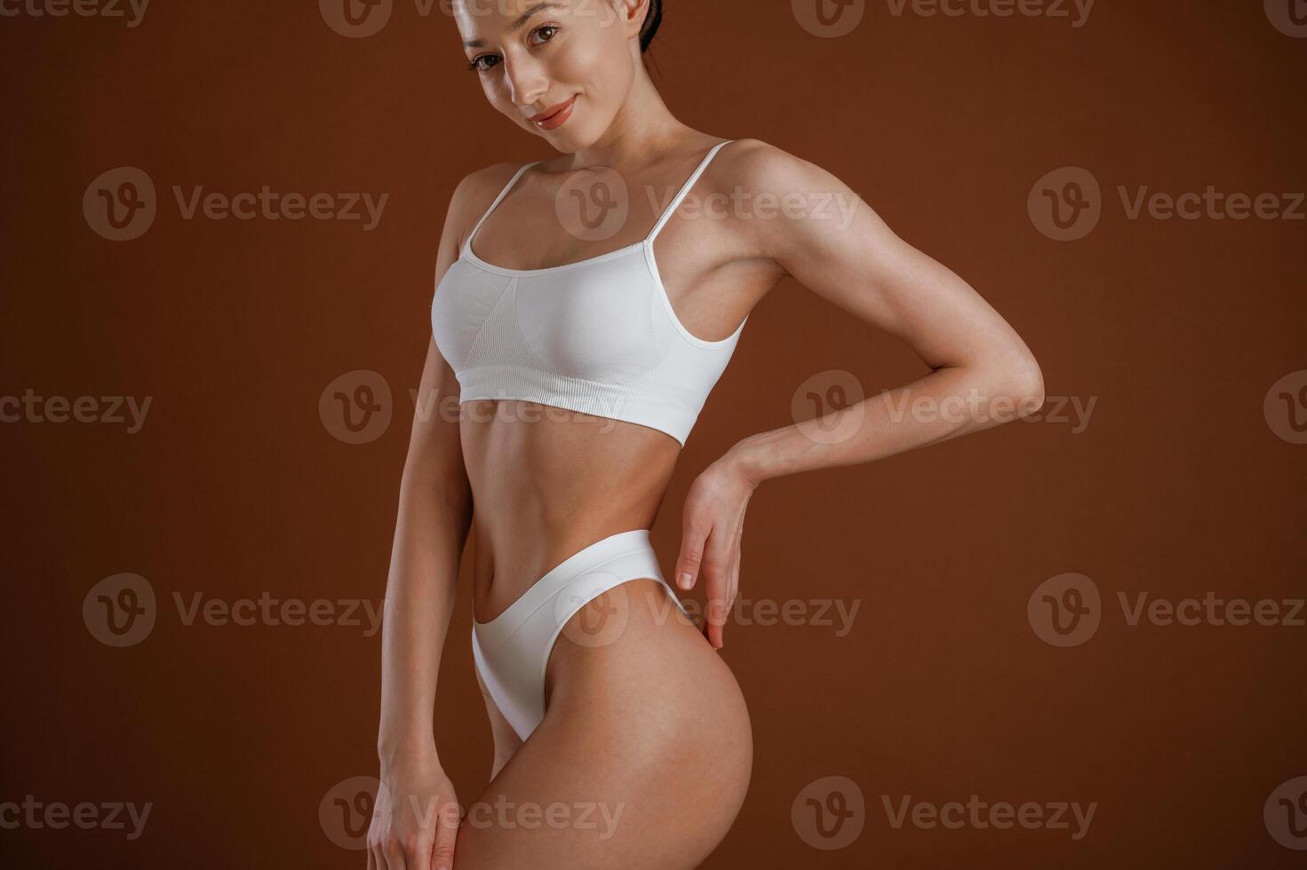 New underwear, collection. Woman ,,with slim body shape is posing against background photo