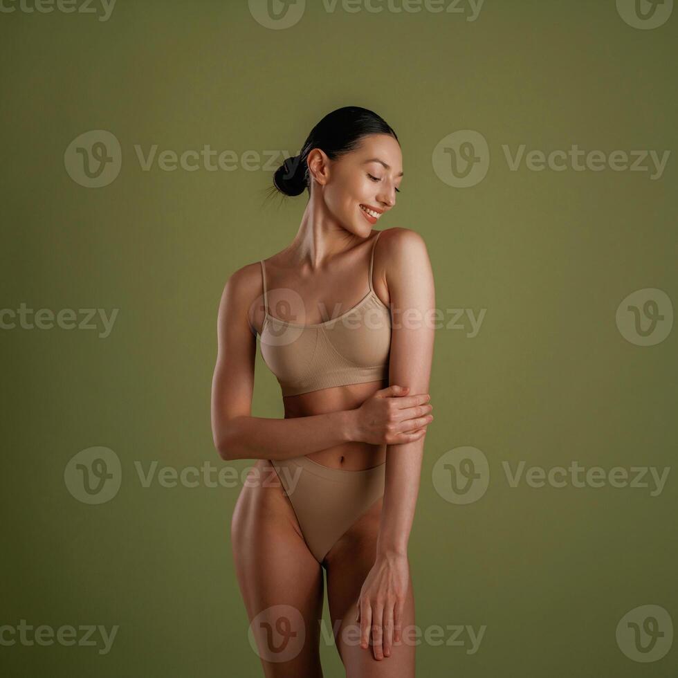 Smiling, ,cheerful ,facial expression.. Woman with slim body shape is posing against background photo