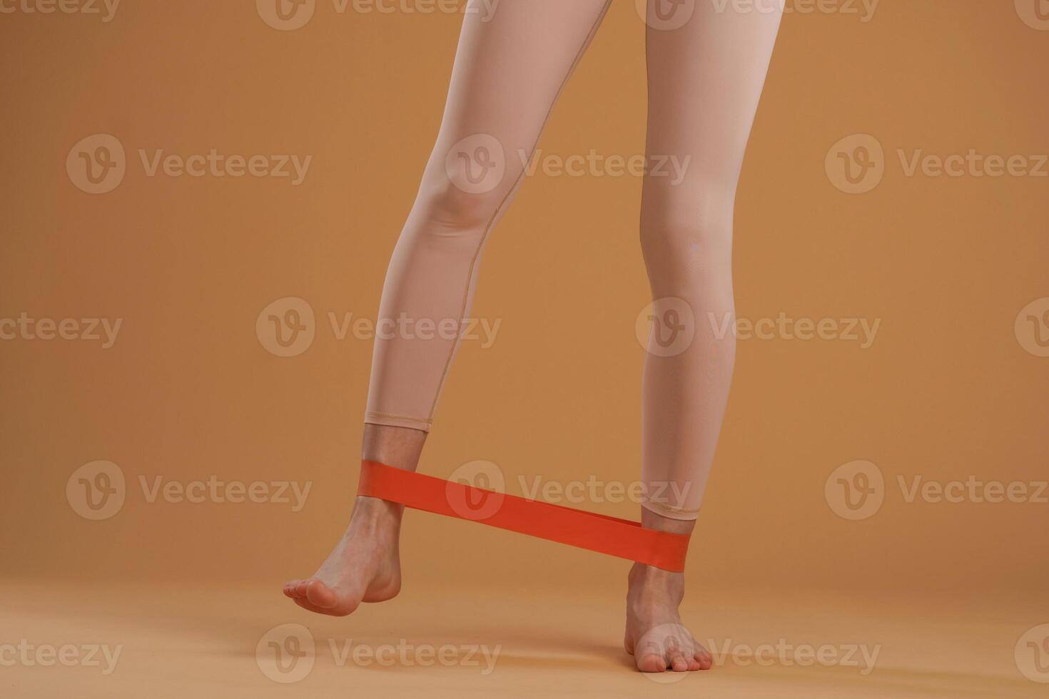 Legs of fitness woman that is in the studio, doing stretching photo