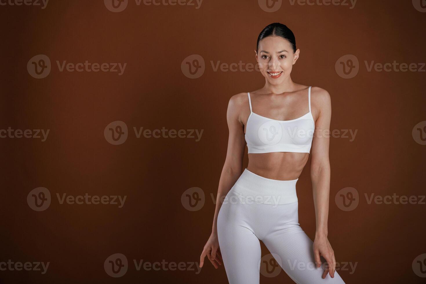 Female, front view,,, smiling. Beautiful fitness woman is in the studio photo