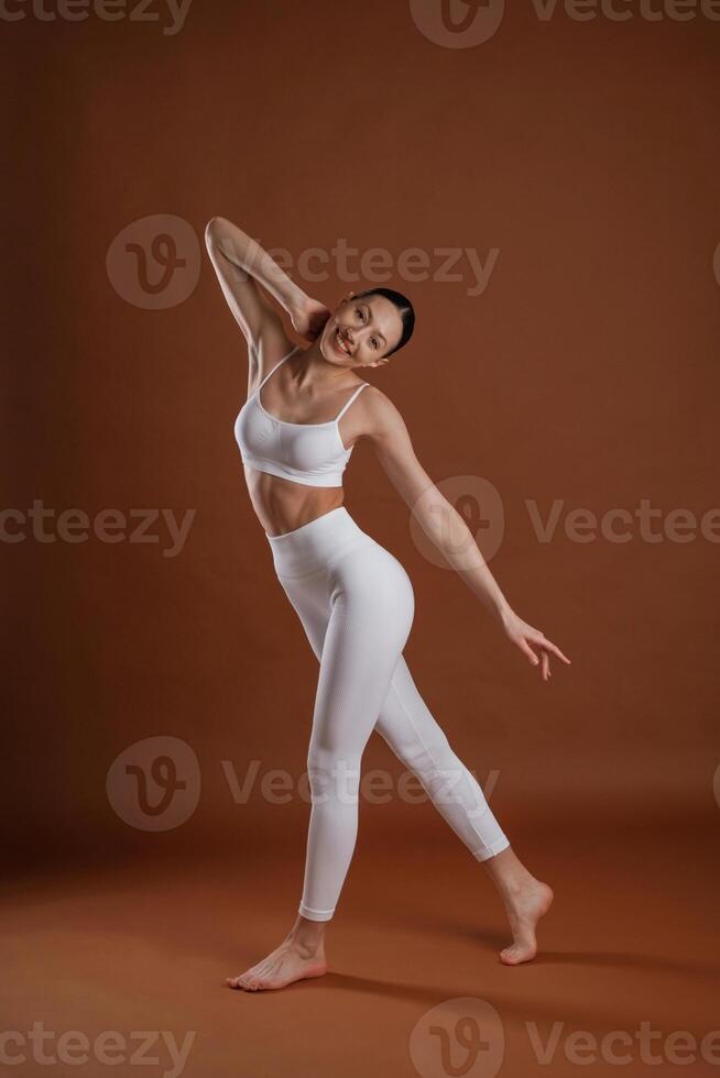 Female, front view, smiling. Beautiful,, fitness woman is in the studio photo