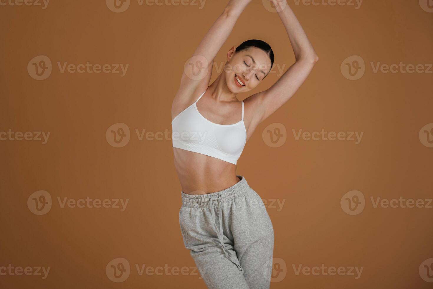 Female, front, view, smiling. Beautiful fitness woman is in the studio photo