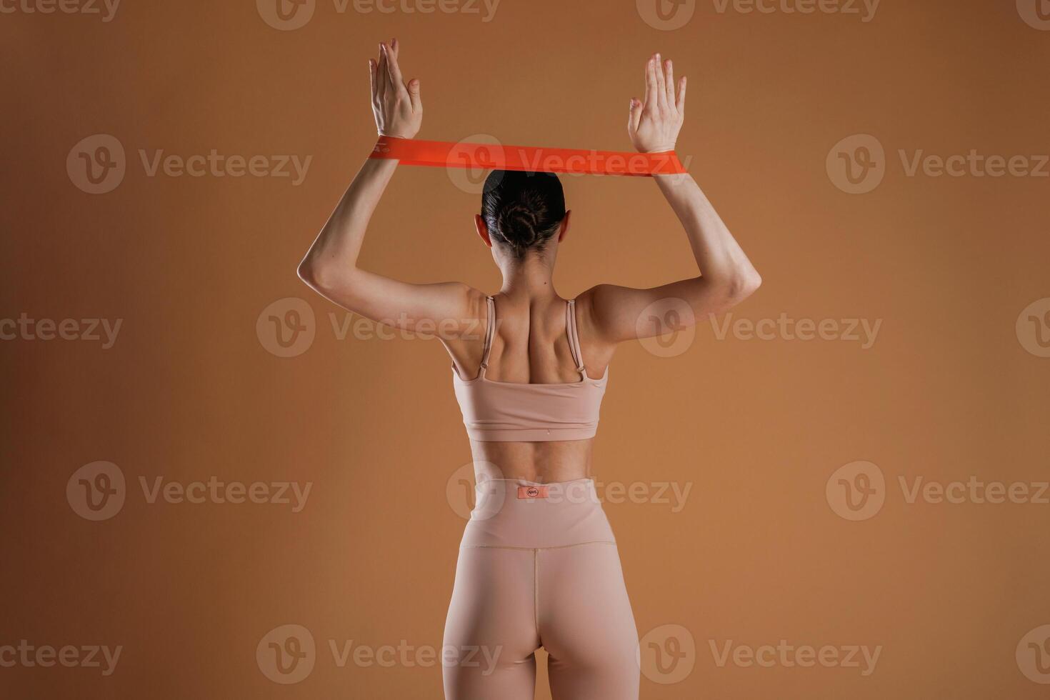 Cloth,, for stretching hands. Beautiful fitness woman is in the studio photo
