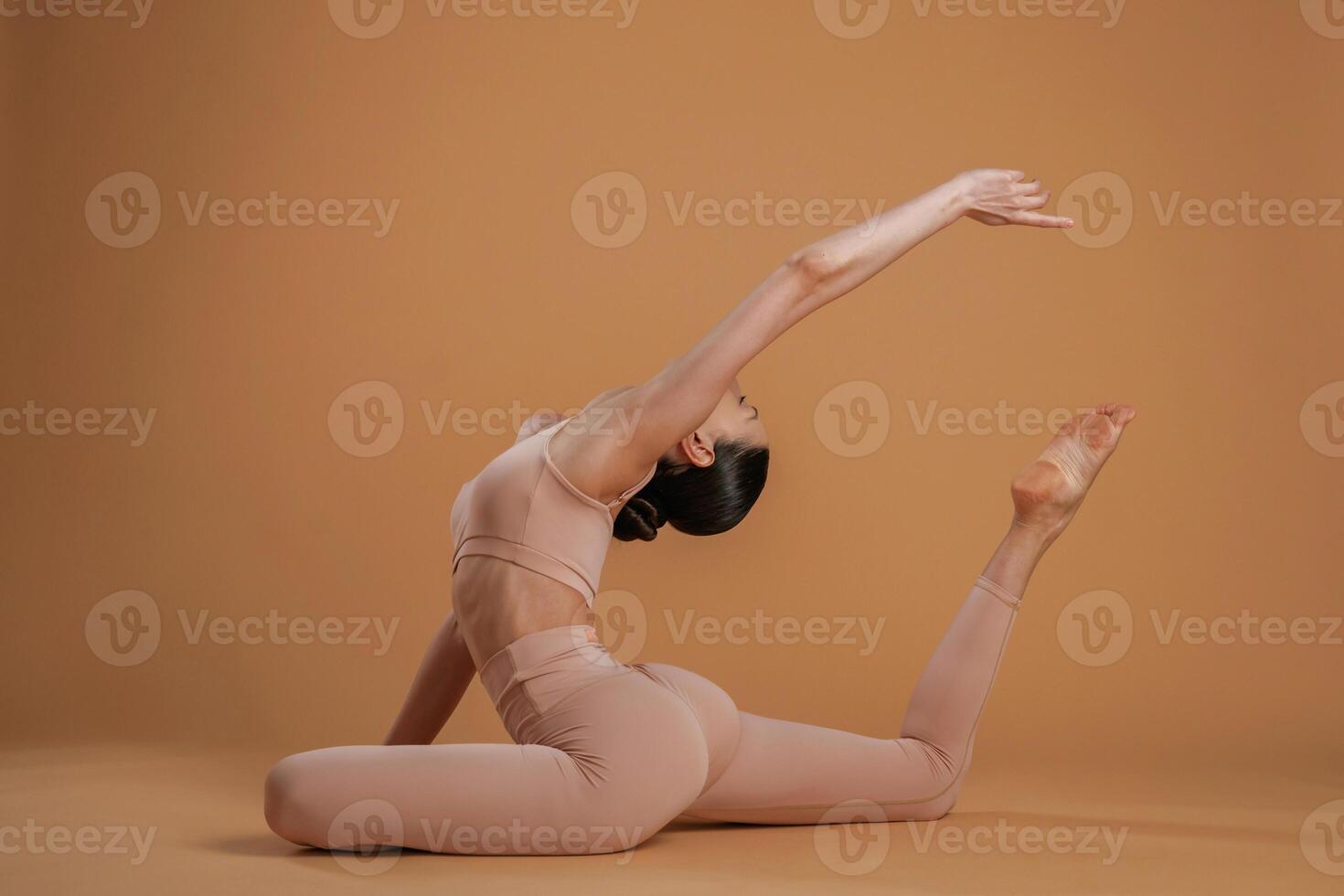 Amazing ,stretch. Beautiful fitness woman is in the studio photo