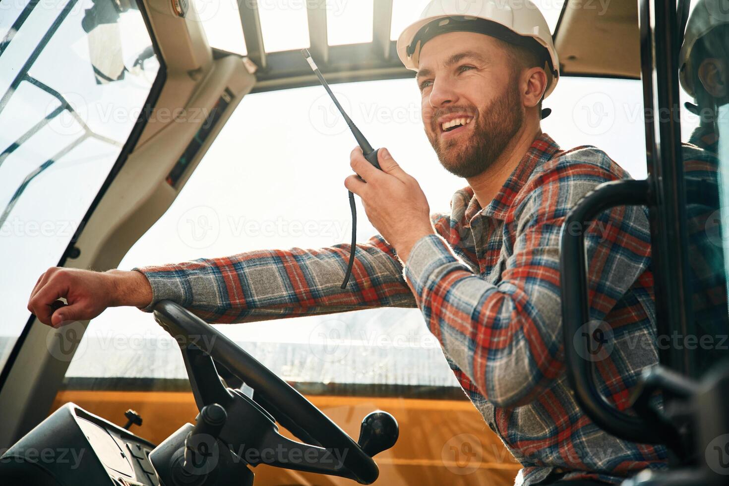Using, radio, talking.. Man is with tractor. Agricultural worker photo