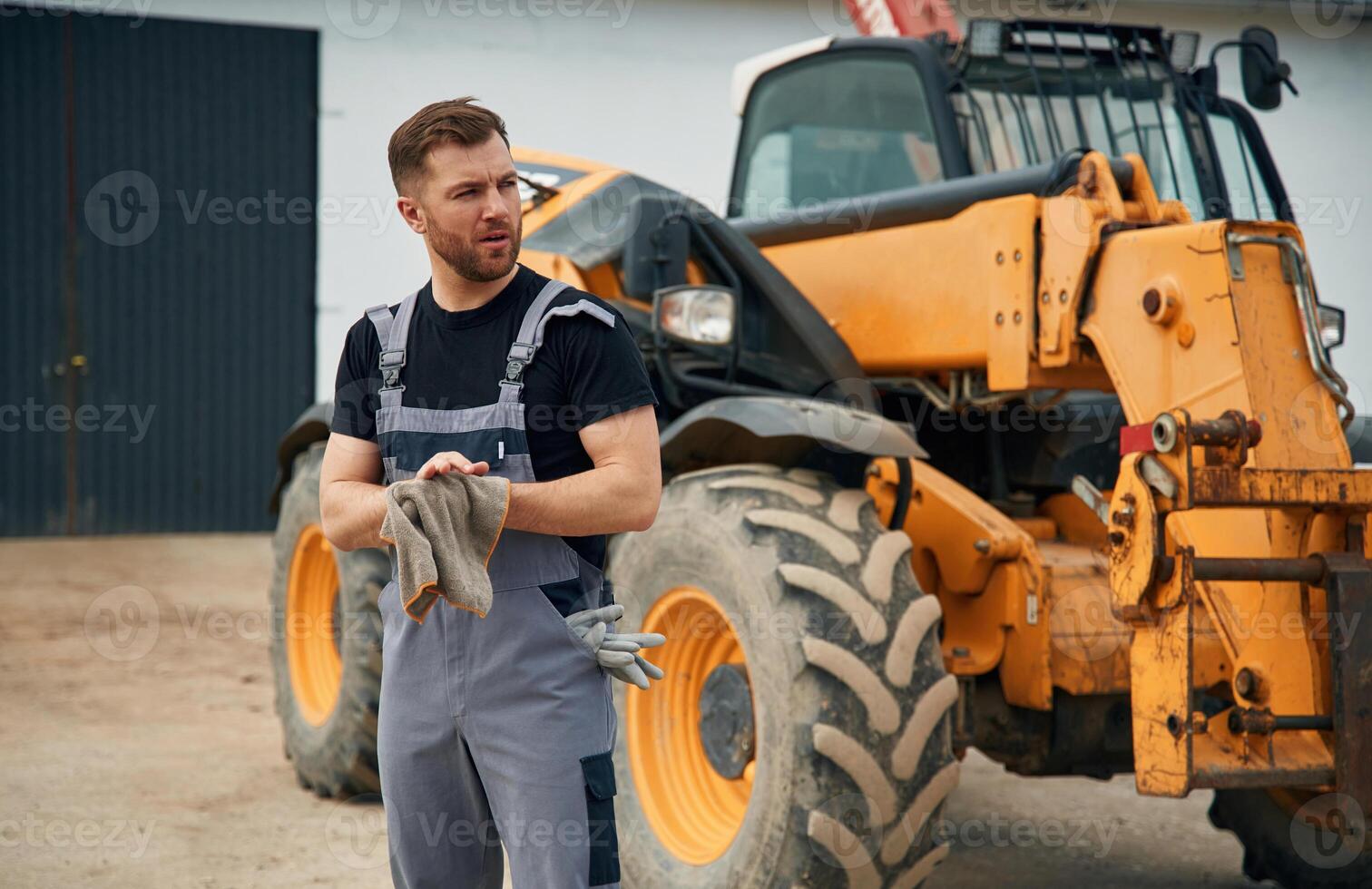 Cleaning the hands after job is done,, mechanic. Man is with tractor. Agricultural worker photo