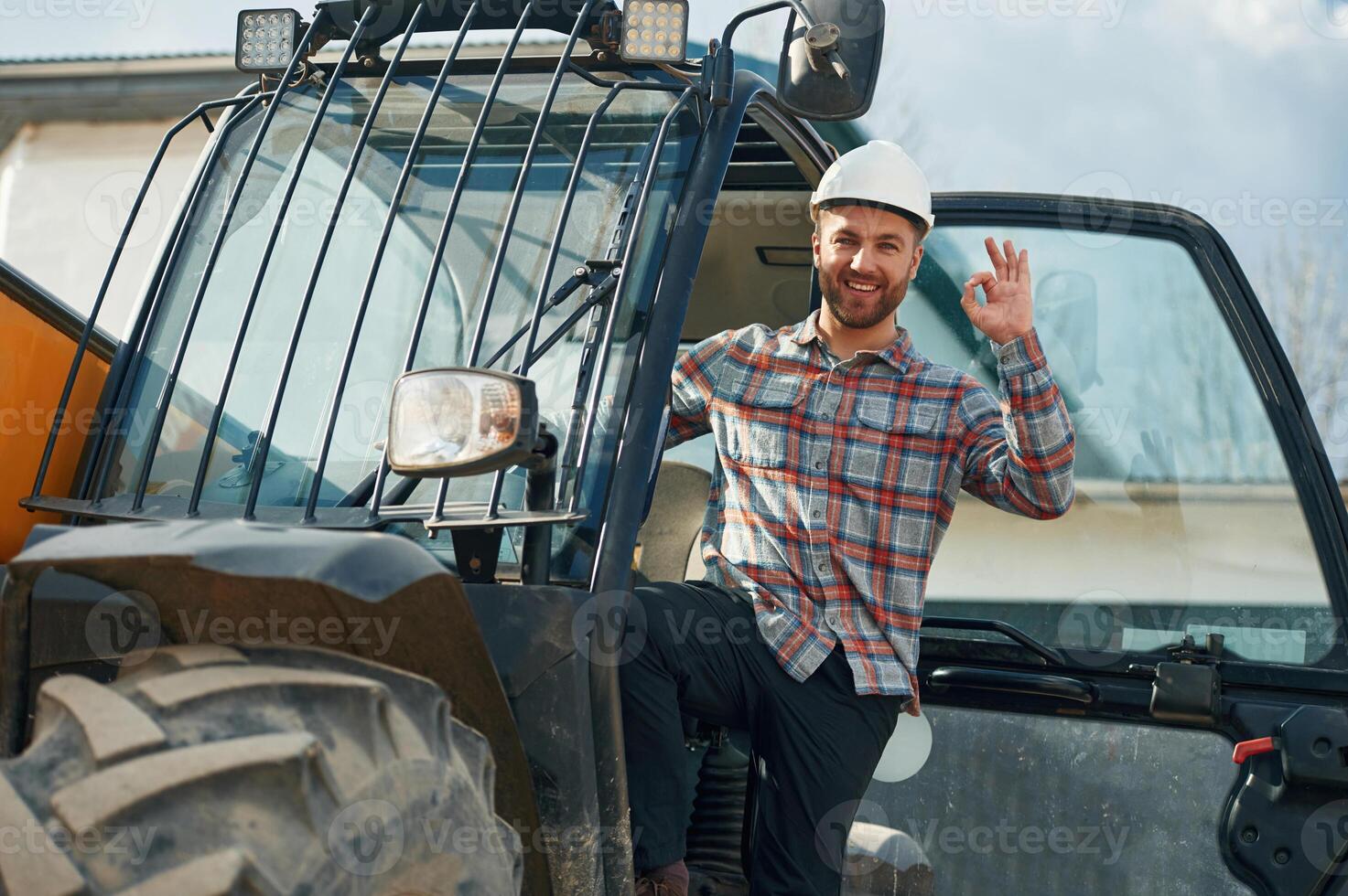 Happy driver. Man ,is with tractor. Agricultural worker photo