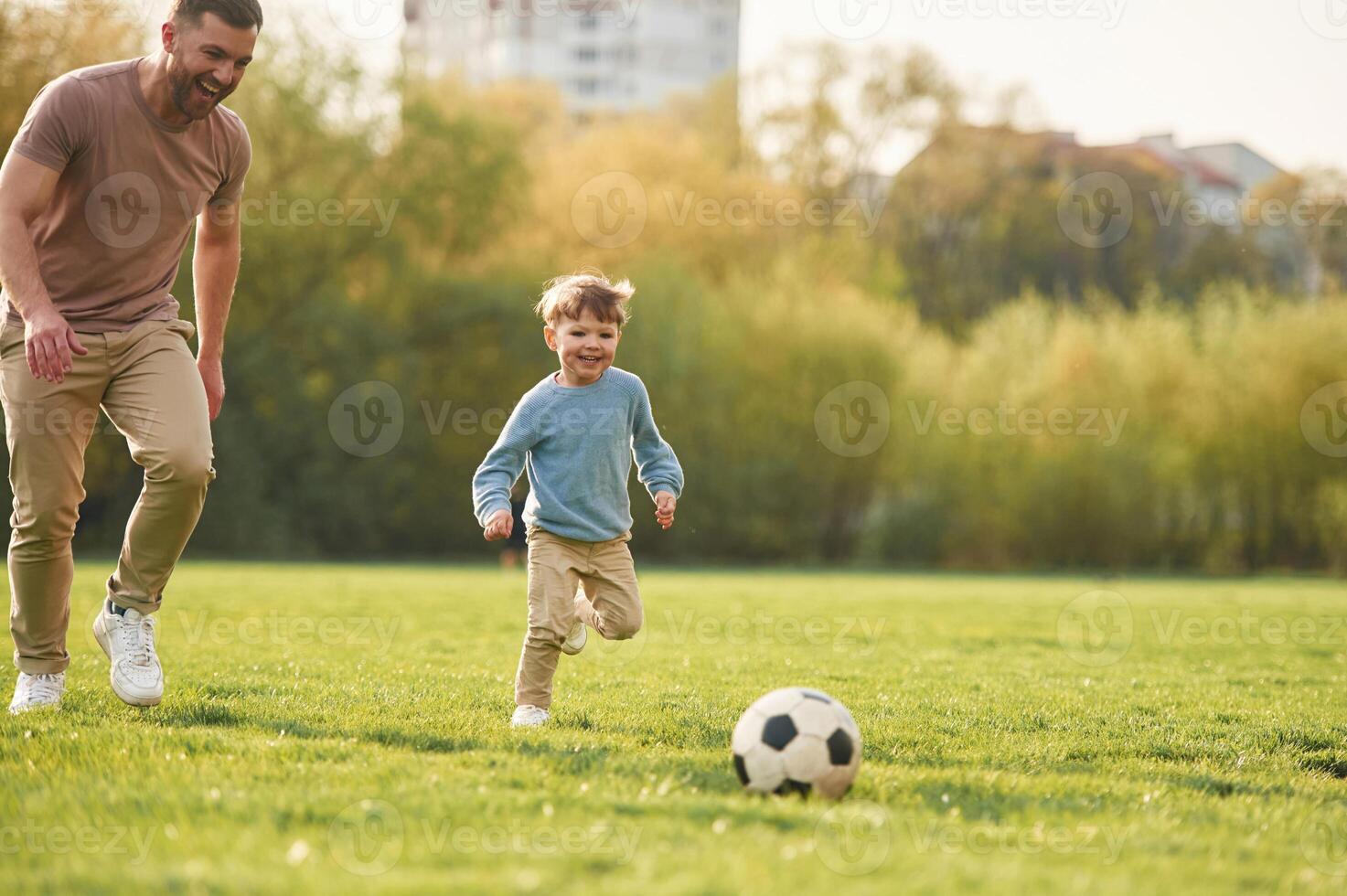 Learning, to, play,, soccer. Happy father with son are having fun on the field at summertime photo