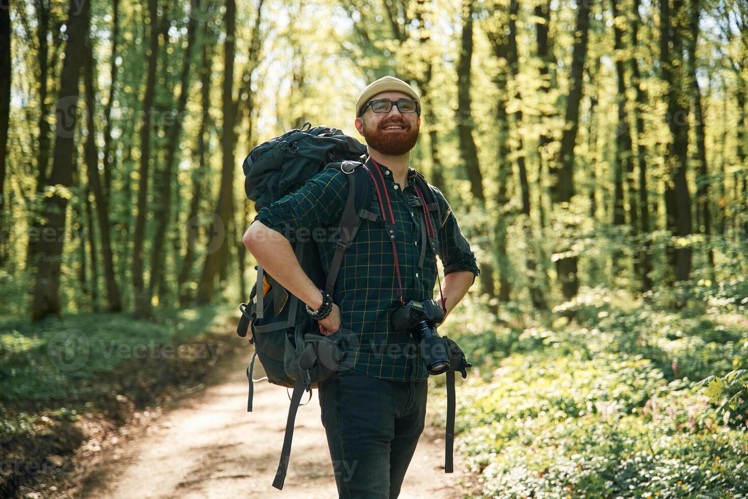 Front, view... Bearded man is in the forest at daytime photo