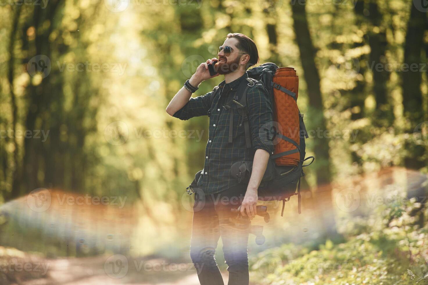 Colorful lens ,effect. Bearded man is in the forest at daytime photo
