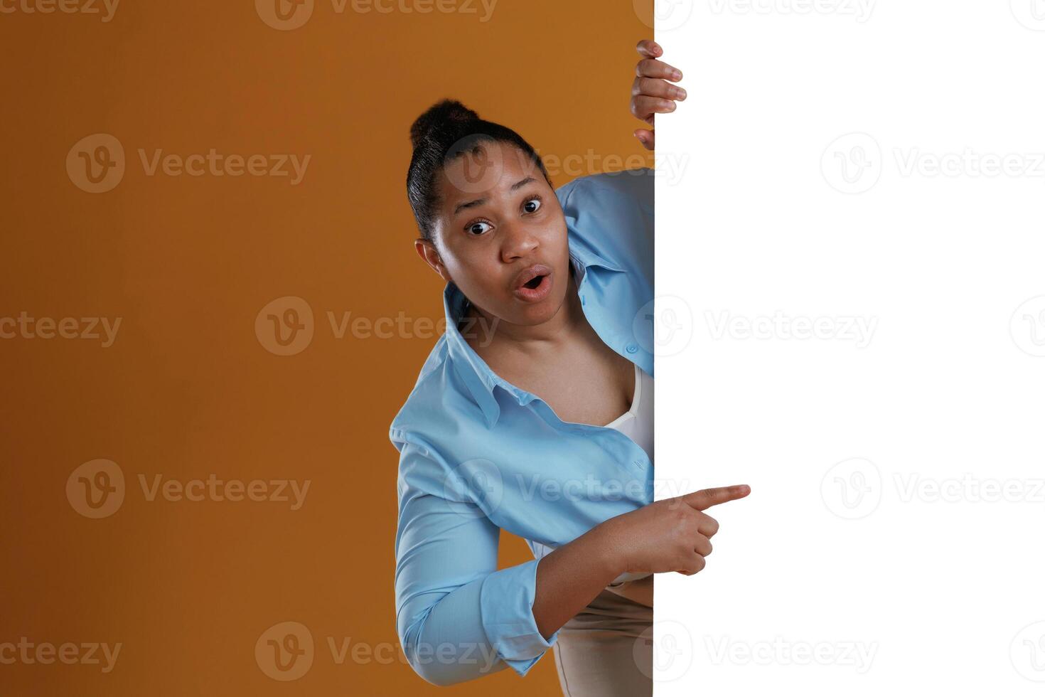Copy space in white color. African American,, woman is in the studio against yellow background photo