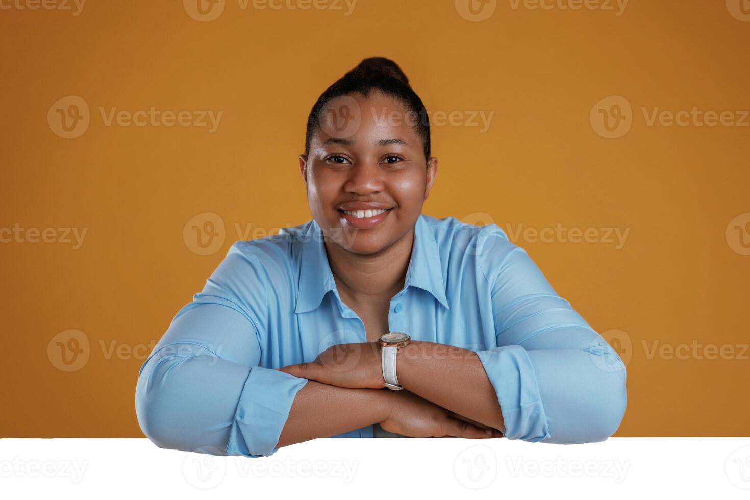 Copy space in white, color. African American woman is in the studio against yellow background photo