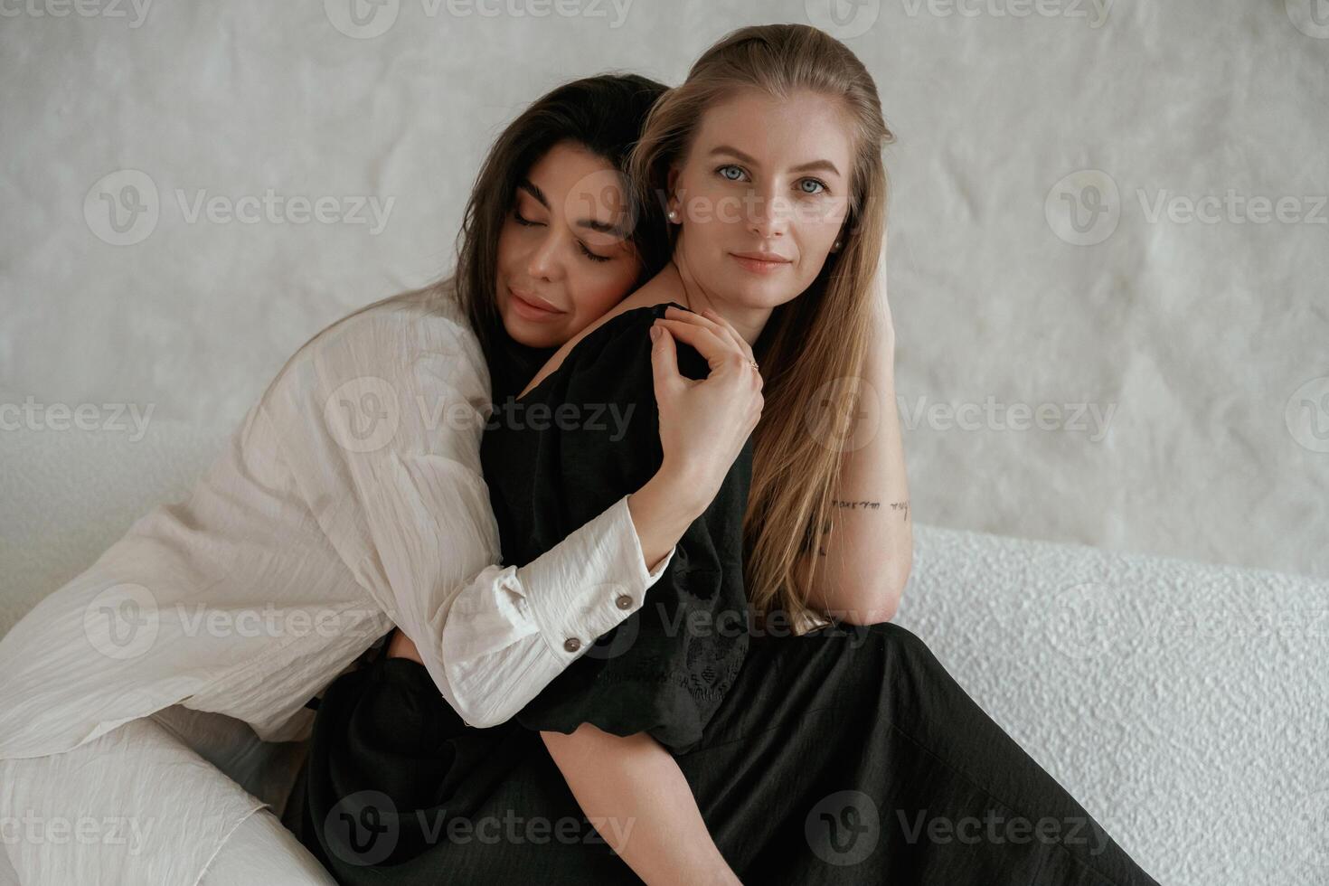 Closeness of ,,the people. Two happ,y young female best friends are indoors photo