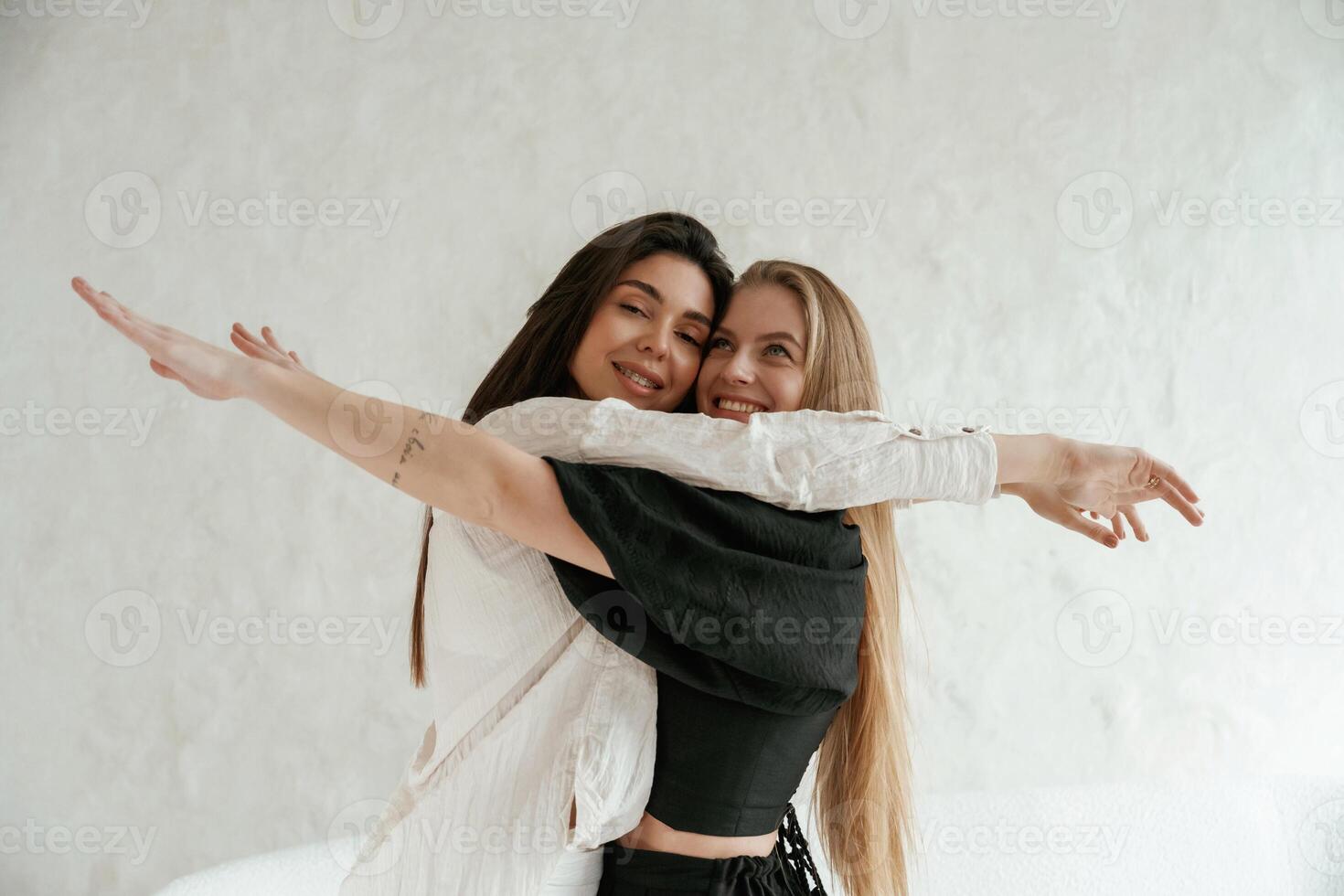 Closeness, of the people. Two happy young female best friends are indoors photo