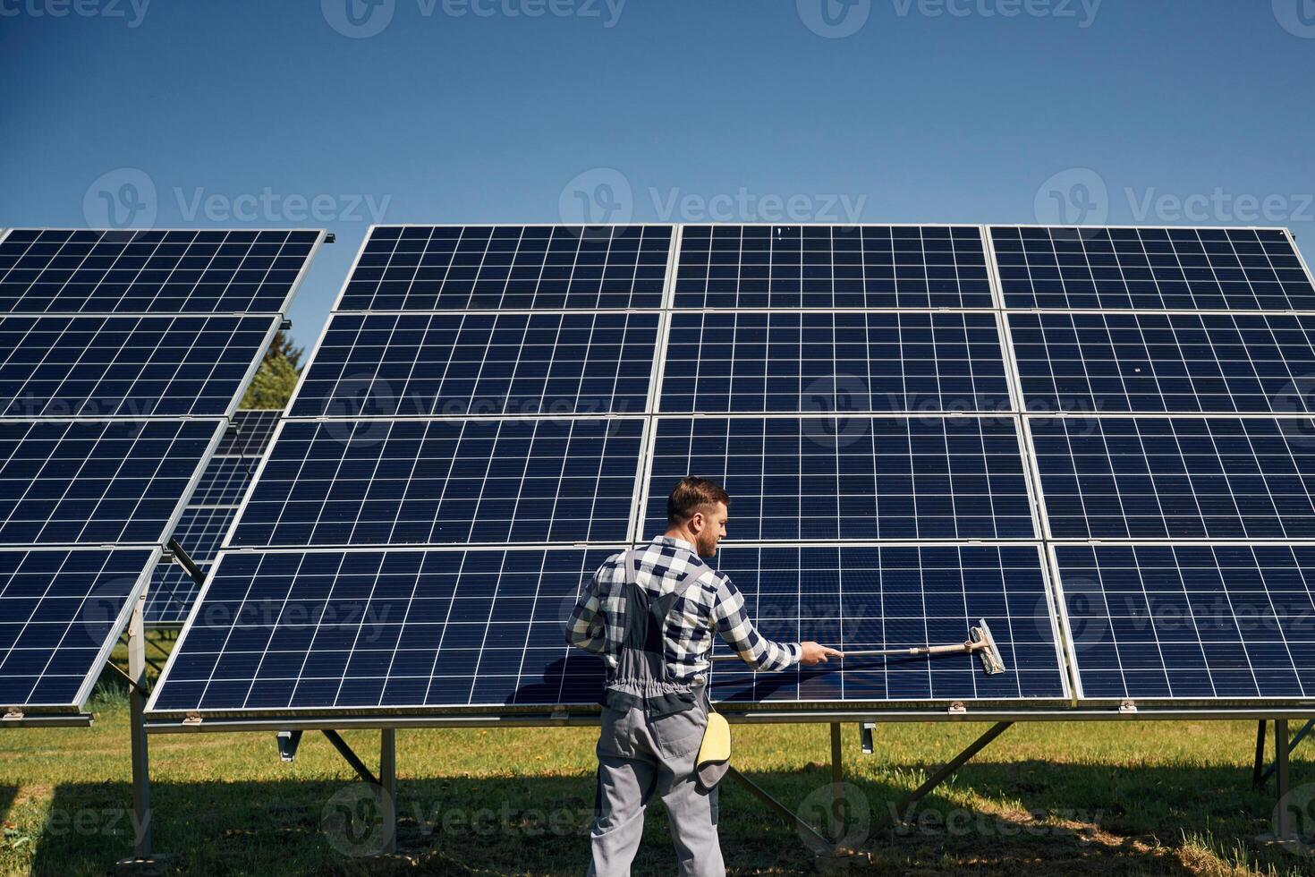 Surface, must me, clean. Engineer with photovoltaic solar panels outdoors at daytime photo