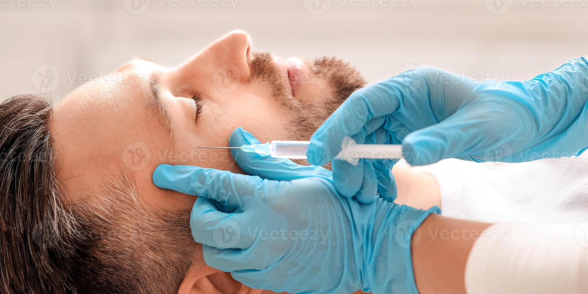Cosmetologist making beauty injections for handsome middle aged man at aesthetic clinic, side view. Man getting lifting procedure against eye wrinkles from unrecognizable plastic surgeon photo
