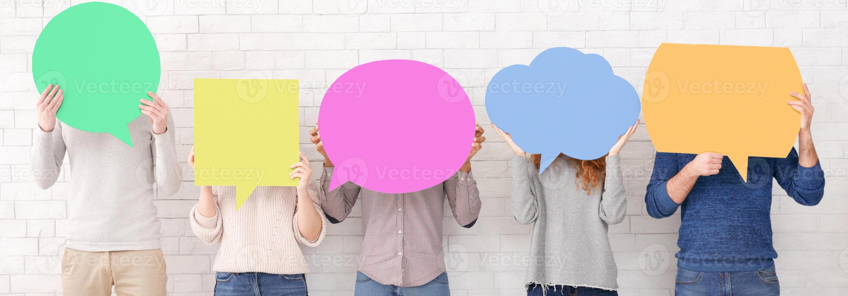 Friends holding speech bubbles with copy space over white wall, crop photo