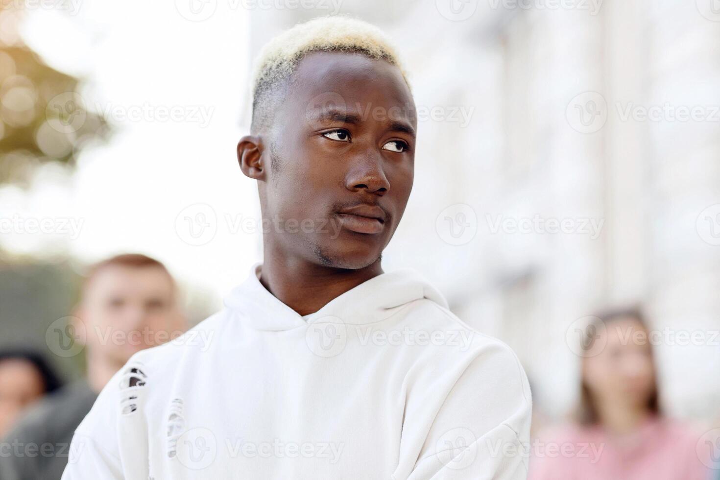 Confident black guy leader standing over multiracial group of millennials fighting for human rights, multiethnic young men and women making protests against rules while lockdown, copy space photo