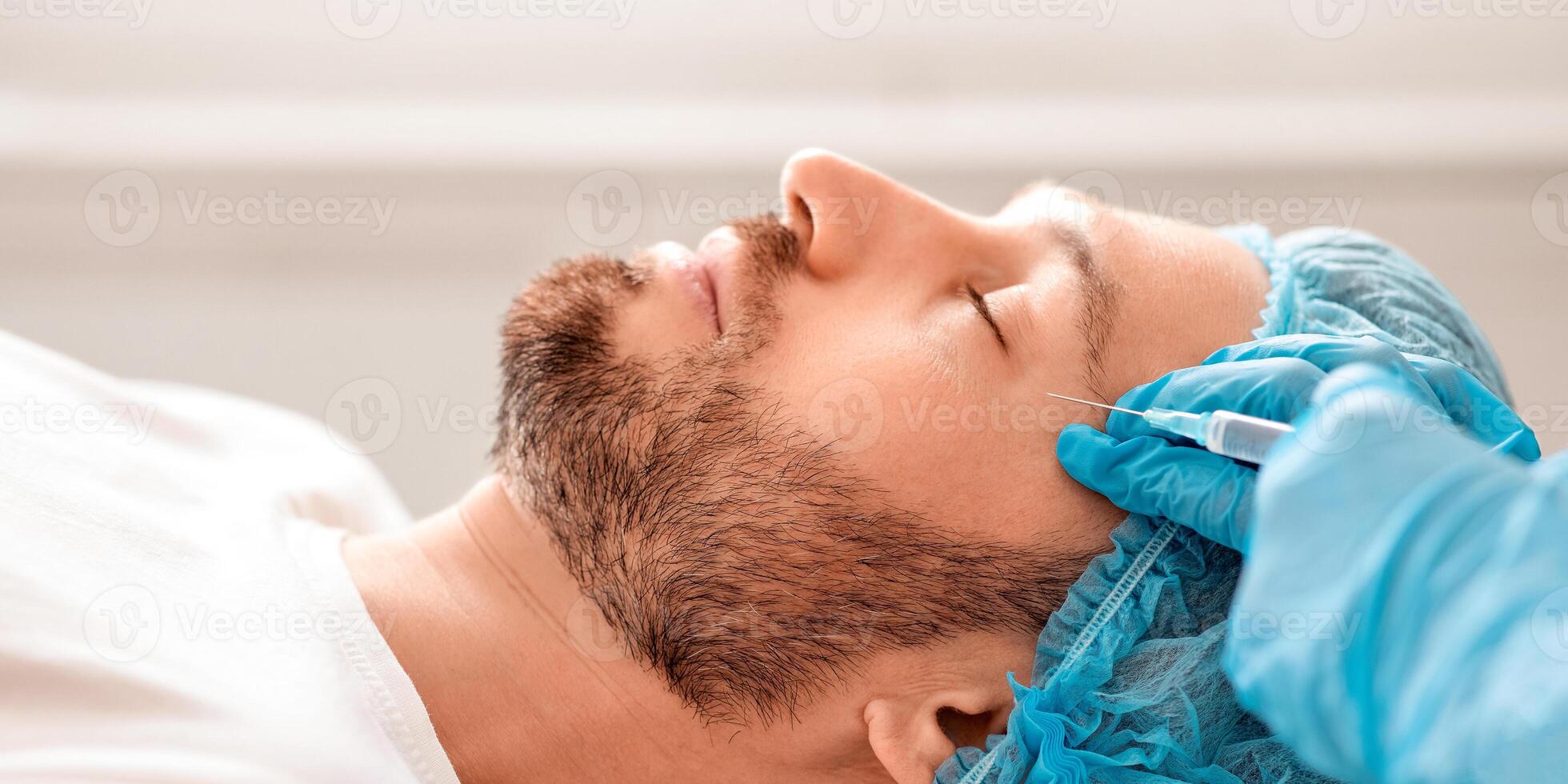 Middle aged man attending aesthetic clinic, getting beauty injection, side view. Bearded man in hair net visiting cosmetologist, having eye lines treatment from plastic surgeon, closeup photo