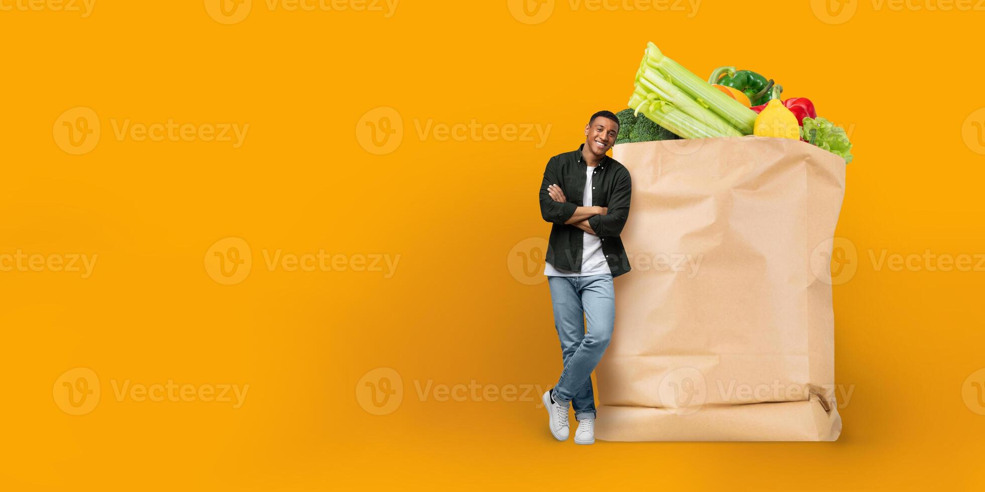 A customer stands beside a large paper bag filled with fresh vegetables, showcasing the current trend of grocery shopping and home delivery, highlighting a new normal in everyday life. photo