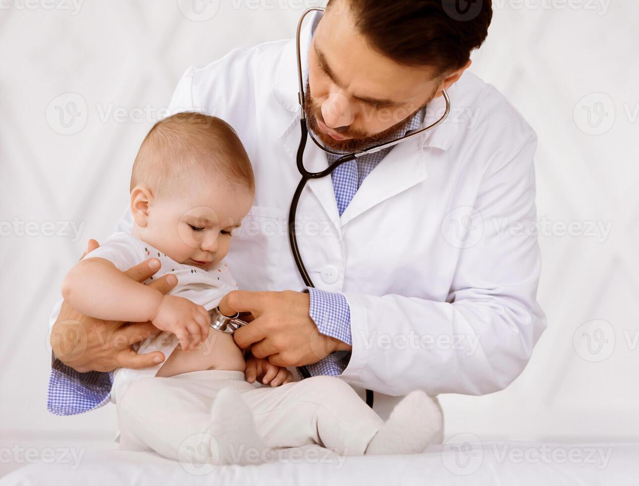 Medical Checkup Concept. Doctor Pediatrician Examining Baby Boy Listening To His Heartbeat Checking Heart And Lungs In Hospital. Sick Little Patient Having Appointment In Clinic. Child Healthcare photo