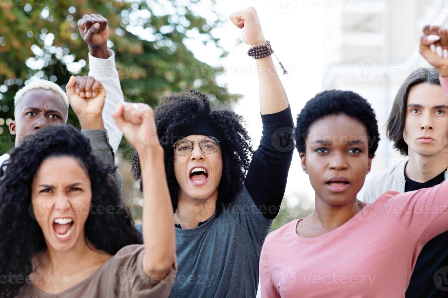 International group of students chanting slogans and showing fists during demonstration, fighting against reforms in education, closeup. Students rally, demonstration, strike concept photo