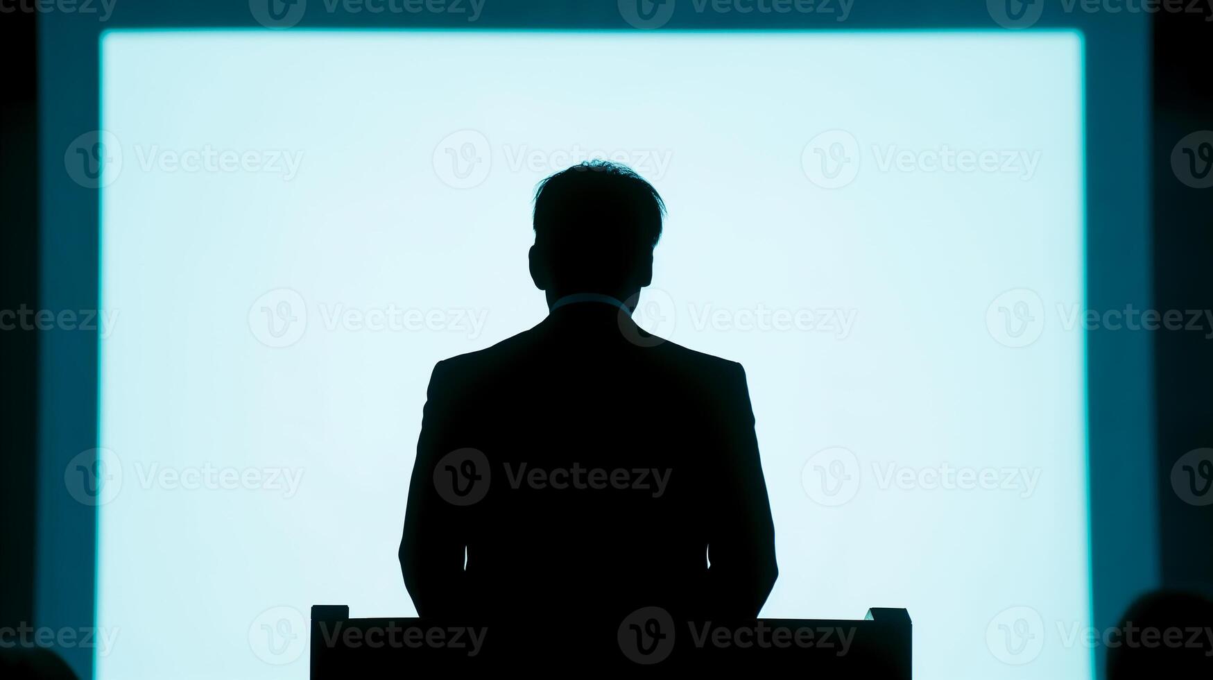 This lawyer speaks to an audience from a podium while delivering a presentation at a conference. photo