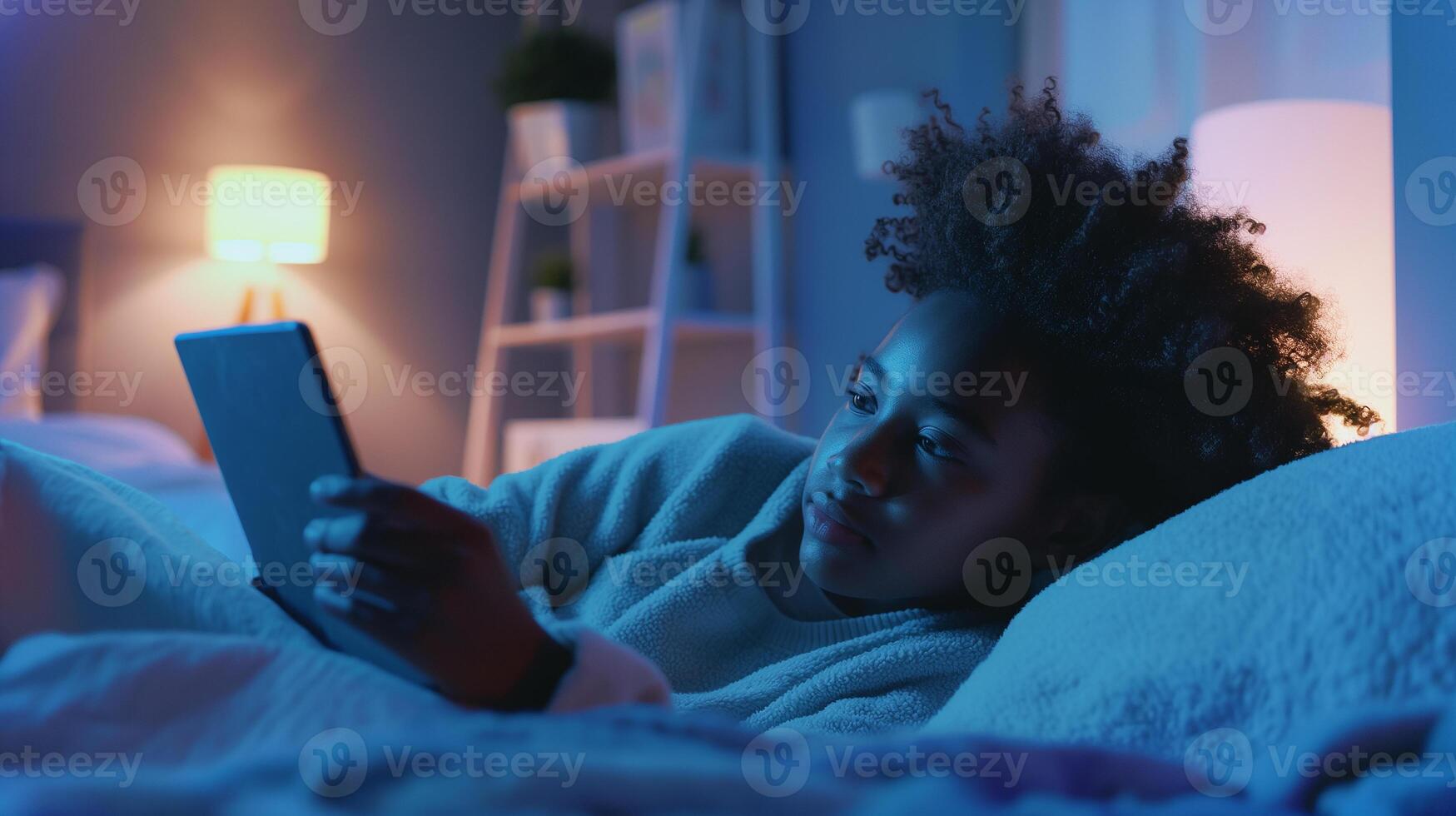 This person is lying on their bed, using a headset for a chat, relaxed in a cozy room. photo