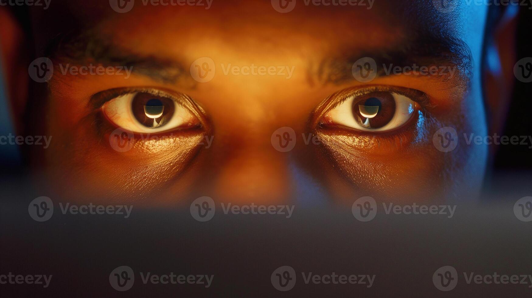 This person is engaged in a call, wearing a headset and focused on the screen. photo