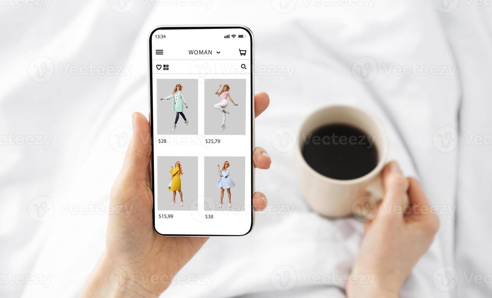 Online Store Application Or Website. Above top overhead view of woman using smartphone, browsing internet shop with clothing and holding cup of coffee. Ecommerce, Retail, Purchase, Sale And Discount photo