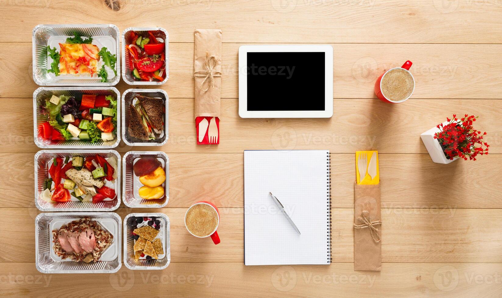 Healthy restaurant food for couple and diet plan. Fresh daily meals delivery. Fitness nutrition, vegetable, meat and fruits in foil boxes, coffee and tablet. Top view, flat lay on wood with copy space photo