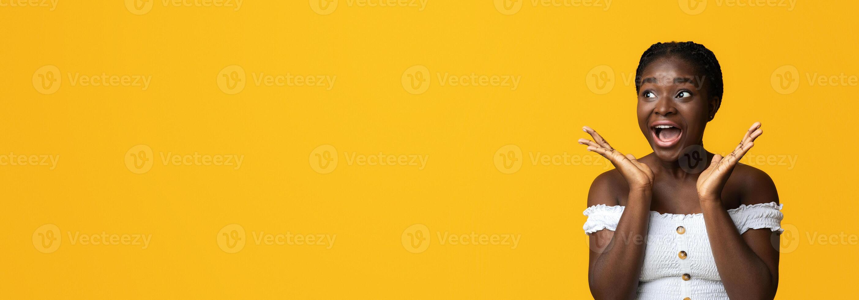 Wow, Great Offer. Emotional Black Woman Exclaiming With Excitement, Looking At Copy Space On Yellow Background, Touching Her Face In Happy Shock, Amazed By Big Sales And Nice Promo, Panorama photo