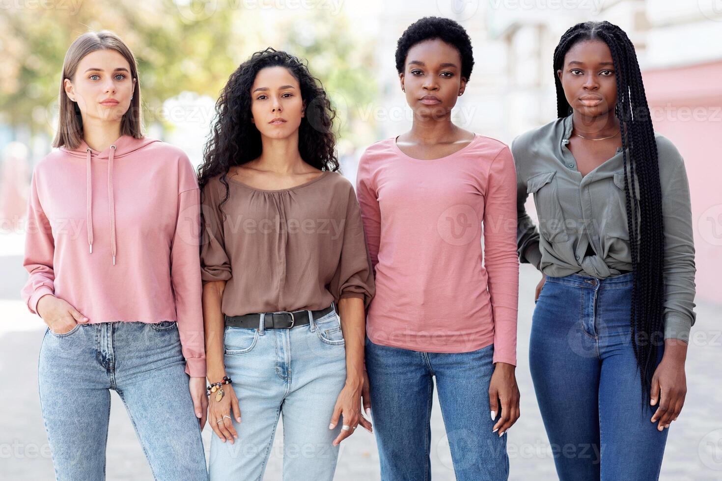 Multiracial group of millennial women in casual standing on the street, having strike. Young multiethnic ladies protestors fighting for women rights. Feminism, womens equality day concept photo