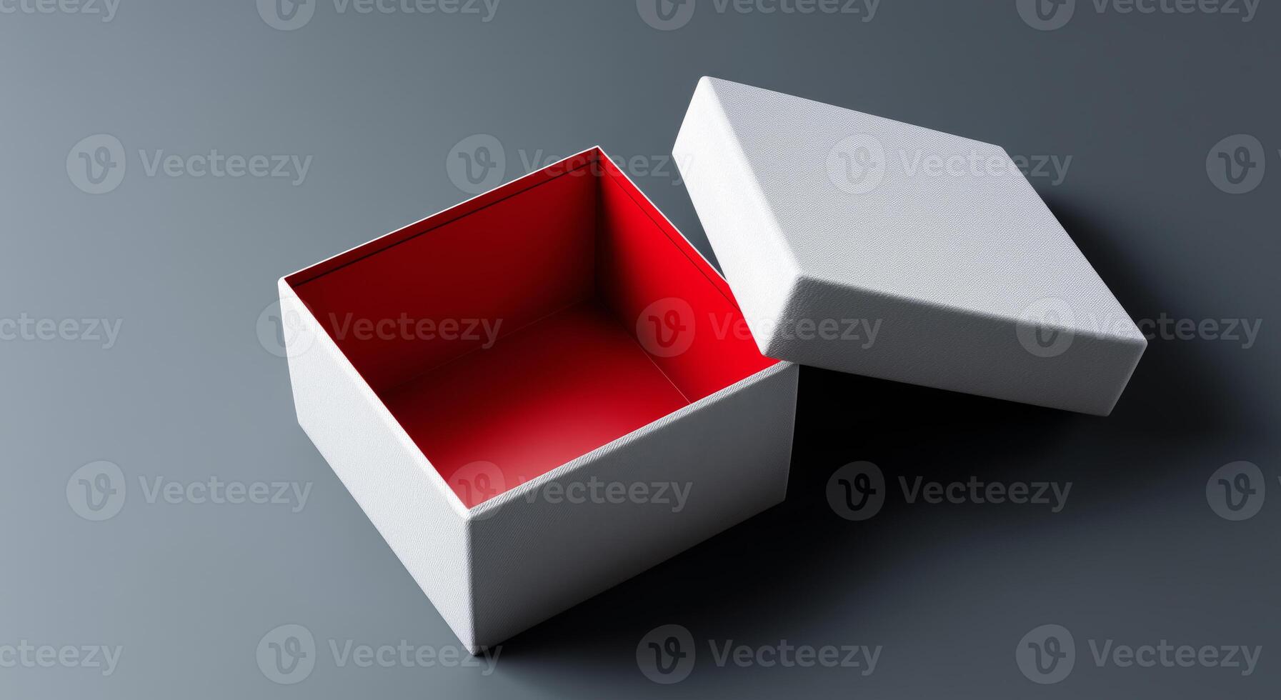 A gift box is open, revealing a bright red interior while resting on a gray surface. The exterior features a soft texture, hinting at the exciting delivery awaiting inside this unwrapped parcel. photo