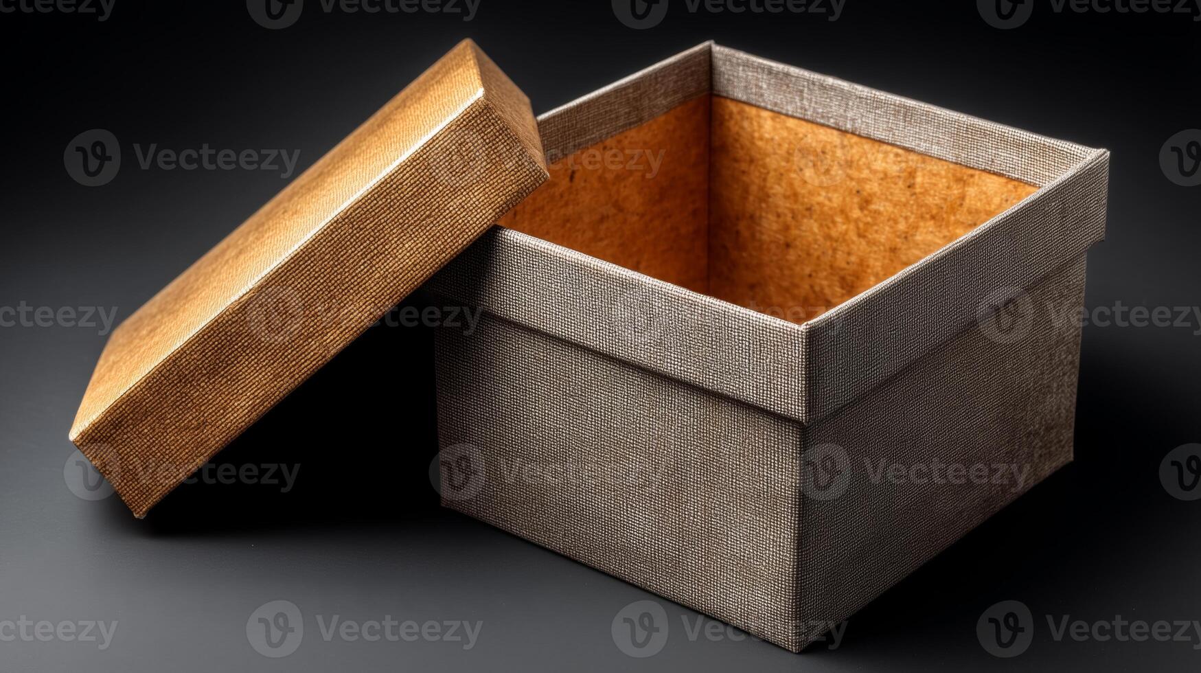 A carefully opened gift box showcases its empty interior. The box features a textured design and sits on a dark surface. This moment captures the anticipation of a special delivery or surprise. photo